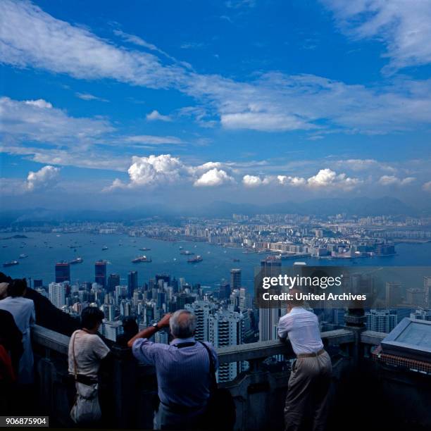 Tourists taking photos of the city of Hong Kong from a viewing platform, early 1980s.