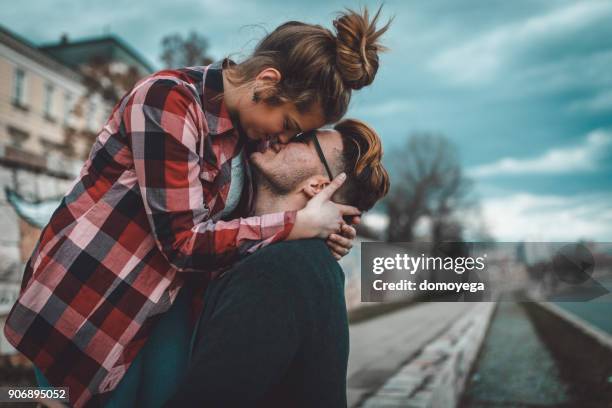 beautiful young couple having fun outdoors on a lovely day - casal romântico imagens e fotografias de stock