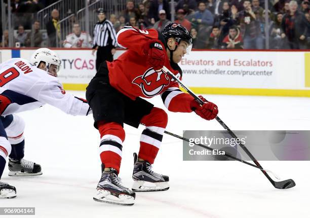 Taylor Hall of the New Jersey Devils heads for the net and scores the game winner as Dmitry Orlov of the Washington Capitals defends in the overtime...