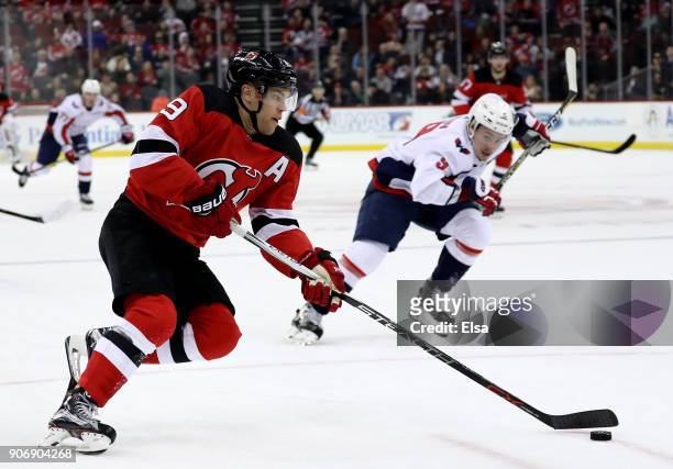 Taylor Hall of the New Jersey Devils heads for the net and scores the game winning goal as Dmitry Orlov of the Washington Capitals defends in the...