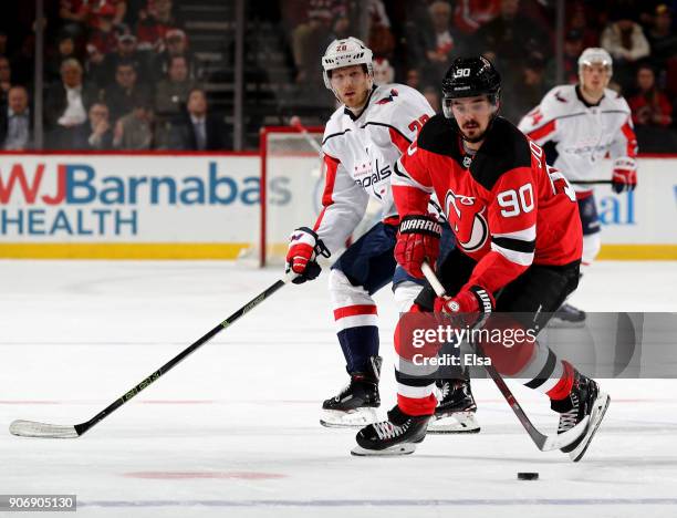 Marcus Johansson of the New Jersey Devils takes the puck as Lars Eller of the Washington Capitals defends on January 18, 2018 at Prudential Center in...
