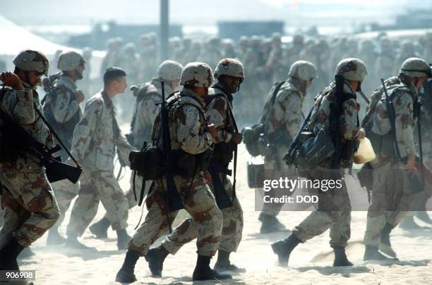 Newly arrived Marines are led through an encampment near an airfield during Operation Desert Shield.