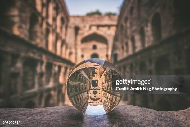 agrasen ki baoli captured inside a crystal ball - agrasen ki baoli imagens e fotografias de stock