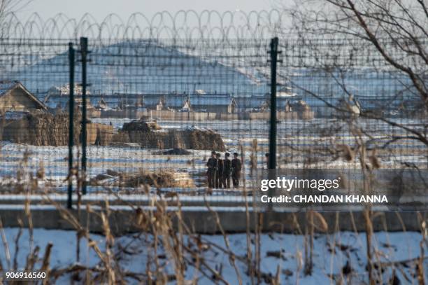 In this photograph taken on January 10, 2018 North Korean soldiers carry out training exercises in the North Korean town of Sinuiju opposite the...