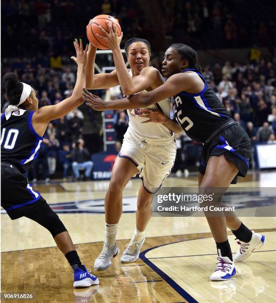 Connecticut's Napheesa Collier drives between Tulsa's Alexis Gaulden and Tatyana Perez at Gampel Pavilion in Storrs, Conn., on Thursday, Jan. 18,...