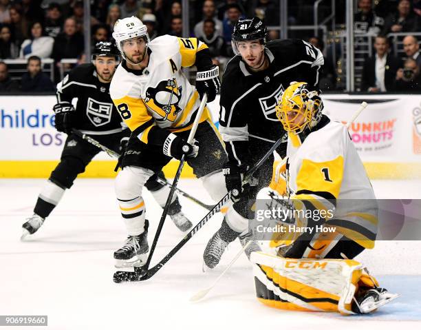 Nick Shore of the Los Angeles Kings look for a rebound with Kris Letang and Casey DeSmith of the Pittsburgh Penguins during the second period at...