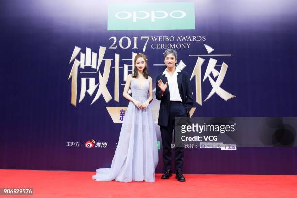Actress Angelababy and actor Deng Chao pose on the red carpet of 2017 Weibo Awards Ceremony at National Aquatics Center on January 18, 2018 in...