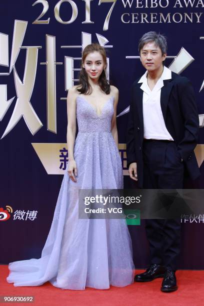 Actress Angelababy and actor Deng Chao pose on the red carpet of 2017 Weibo Awards Ceremony at National Aquatics Center on January 18, 2018 in...