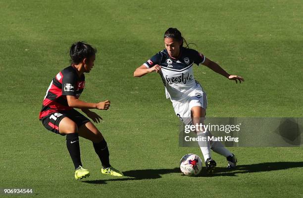 Angela Beard of the Victory is challenged by Rasamee Phonsongkham of the Wanderers during the round 12 W-League match between the Western Sydney...