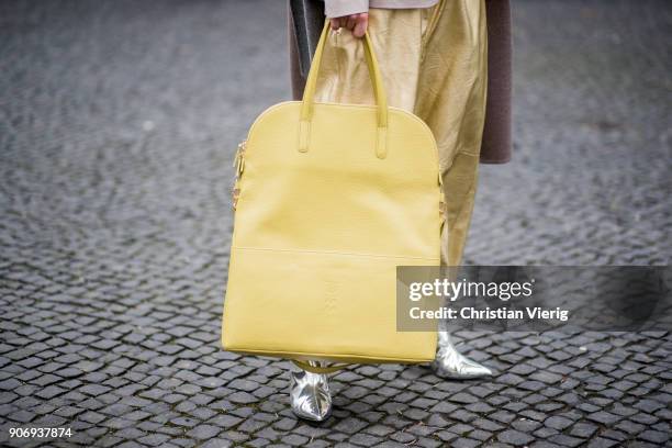 Gitta Banko wearing golden paper trousers by MM6 Martin Margiela, silver blouse from H&M, shiny beige leather blazer by Dawid Tomaszewski, taupe...