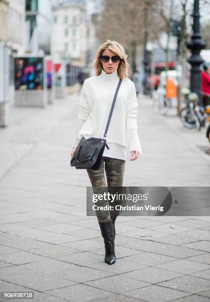 Gitta Banko wearing camouflage patterned jeans by True Religion, white cotton blouse with large, pleated sleeves and white turtleneck sweater by Soul...