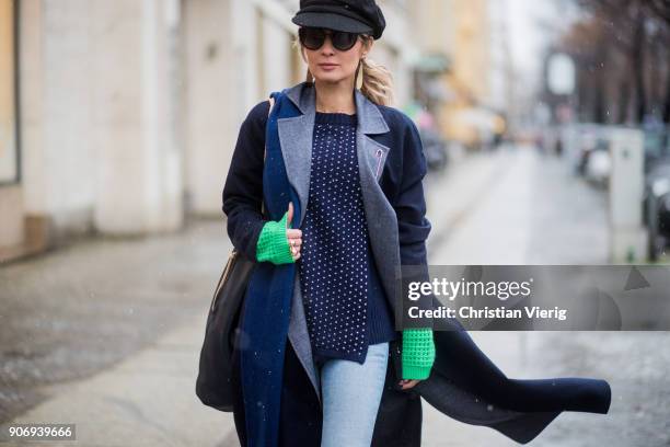 Gitta Banko wearing a total Agnona look containing a navy blue, white dotted knit sweater with green sleeves, navy blue cashemere scarf, dark blue...