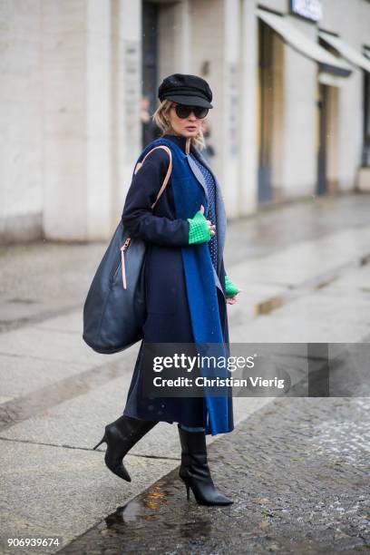 Gitta Banko wearing a total Agnona look containing a navy blue, white dotted knit sweater with green sleeves, navy blue cashemere scarf, dark blue...