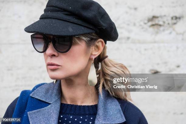 Gitta Banko wearing a total Agnona look containing a navy blue, white dotted knit sweater with green sleeves, navy blue cashemere scarf, dark blue...