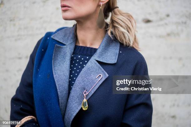 Gitta Banko wearing a total Agnona look containing a navy blue, white dotted knit sweater with green sleeves, navy blue cashemere scarf, dark blue...