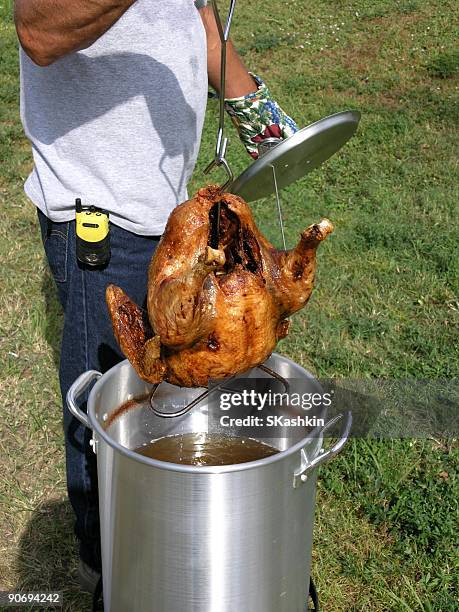 dip frying turkey - fried turkey stock pictures, royalty-free photos & images