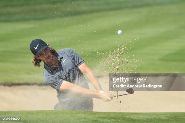 Tommy Fleetwood of England plays his third shot from a bunker on the second hole during round two of the Abu Dhabi HSBC Golf Championship at Abu...