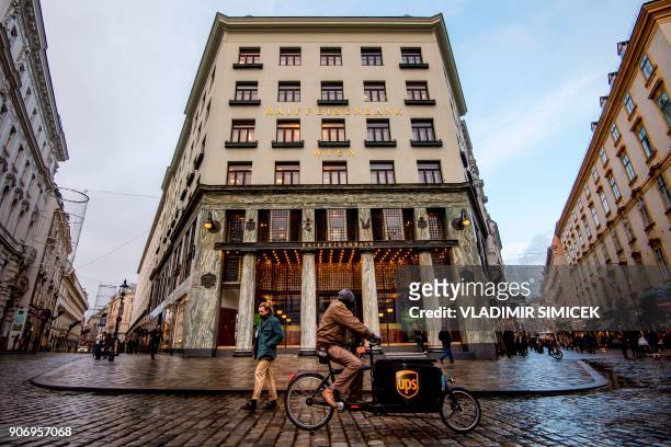 People pass in front of the "Looshaus", a modernist building designed by the architect Adolf Loos in 1910 at the Michaelerplatz, downtown Vienna on...