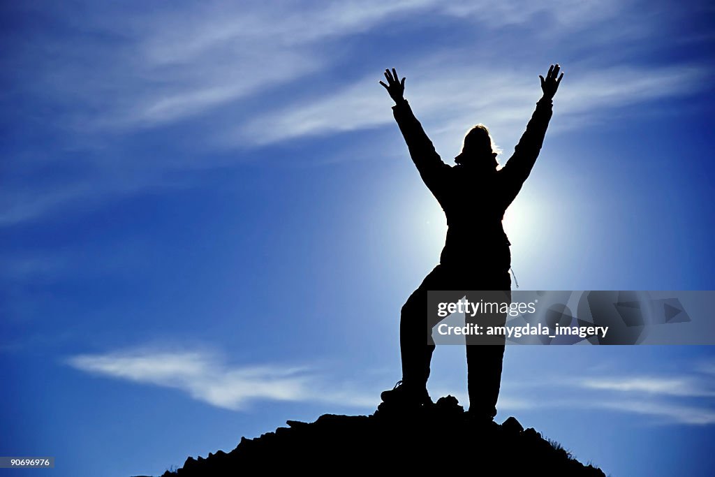 Celebrating the blue sky (woman silhouette with arms raised high)!