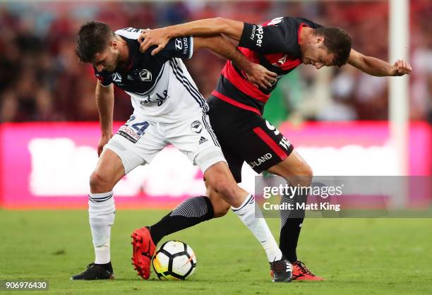 Terry Antonis of the Victory competes for the ball against Oriol Riera of the Wanderers during the round 17 A-League match between the Western Sydney...