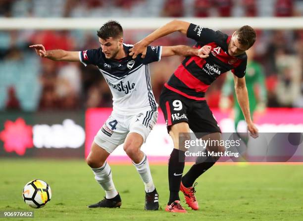 Terry Antonis of the Victory competes for the ball against Oriol Riera of the Wanderers during the round 17 A-League match between the Western Sydney...