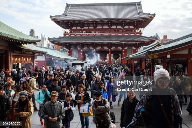 Tourists stroll around the grounds of Senso-ji buddhist temple, on January 19, 2018 in Tokyo, Japan. Senso-ji, is Tokyo's oldest temple, dating back...