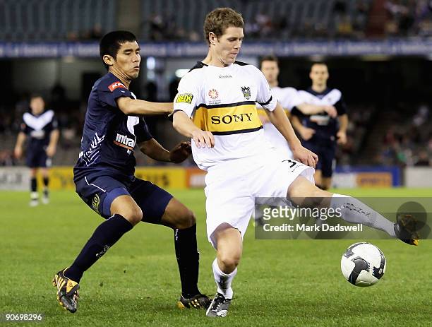 Tony Lochhead of the Phoenix controls the ball ahead of Surat Sukha of the Victory during the round six A-League match between the Melbourne Victory...