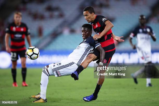 Leroy George of the Victory is challenged by Kearyn Baccus of the Wanderers during the round 17 A-League match between the Western Sydney Wanderers...