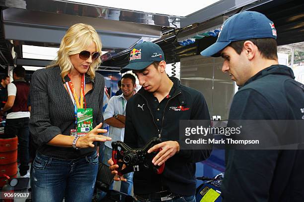 Television presenter Natasha Stefanenko meets drivers Sebastien Buemi of Switzerland and Jaime Alguersuari of Spain in the Scuderia Toro Rosso garage...