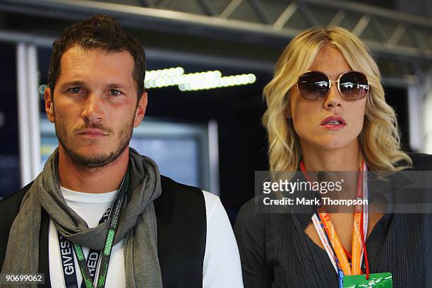Television presenters Alvin and Natasha Stefanenko are seen in the Scuderia Toro Rosso garage before the Italian Formula One Grand Prix at the...