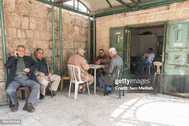 Men playing cards next to Herod's Gate in the Old City on 31st March 2016 in Jerusalem, West Bank.