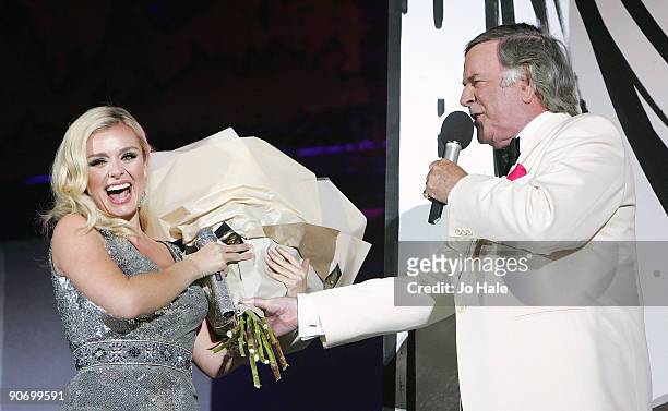 Katherine Jenkins receives flowers presented by Terry Wogan on stage at the BBC Proms In The Park at Hyde Park on September 12, 2009 in London,...