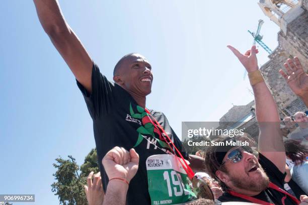 Mervin Steenkamp, South African, celebrates after winning his first international marathon at the 2016 Right to Movement Palestine Marathon in Manger...