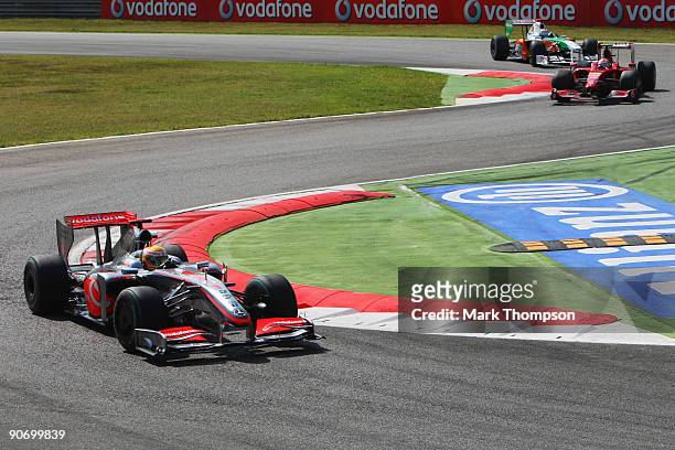 Lewis Hamilton of Great Britain and McLaren Mercedes leads from Kimi Raikkonen of Finland and Ferrari and Adrian Sutil of Germany and Force India at...