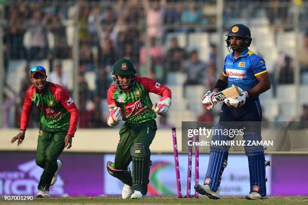 Sri Lanka cricketer Kusal Perera is bowled out by the Bangladesh cricketer Nasir Hossain as his teammate wicketkeeper Mushfiqur Rahim and Sabbir...