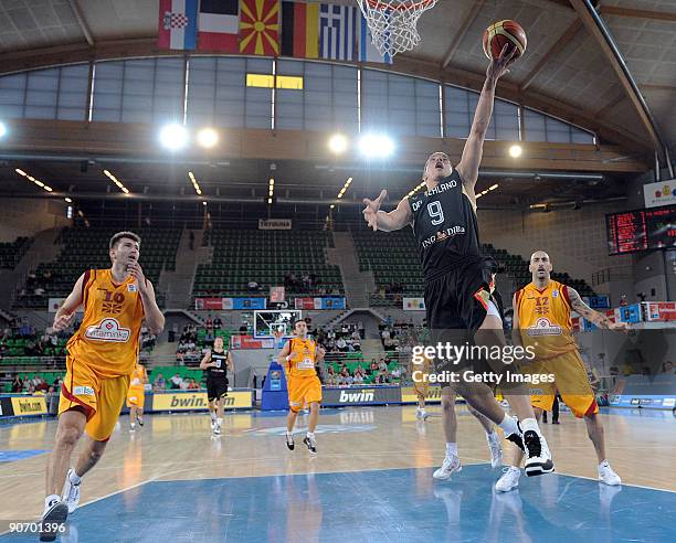 Steffen Hamann of Germany shoots against Dime Tasovski of F.Y.R. Of Macedonia during the EuroBasket 2009 Qualifying Round Group E match between...