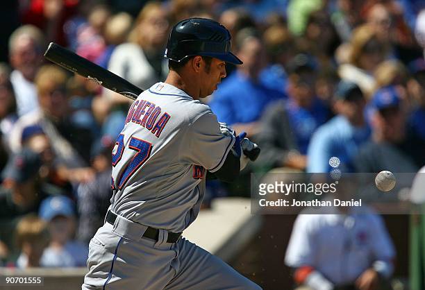Nelson Figueroa of the New York Mets looks at the ball after fouling off a pitch while hitting against the Chicago Cubs on August 30, 2009 at Wrigley...