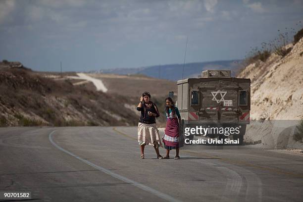 Jewish settlers hitchhike after a violent clash between settlers and Israeli security forces erupted at a West Bank outpost of Havat Gilad on...