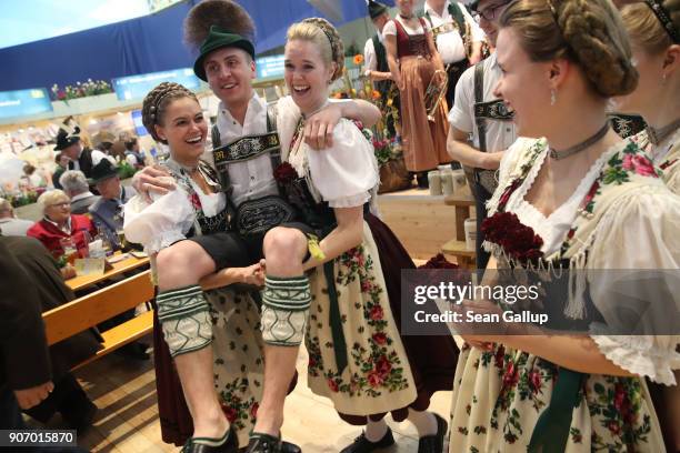 Young men and women from the Chiemsee region of Bavaria and wearing Bavarian folk costumes attend the 2018 International Green Week agricultural...