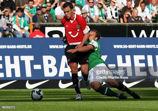 Philipp Bargfrede of Bremen and Hanno Balitsch of Hannover battle for the ball during the Bundesliga match between Werder Bremen and Hannover 96 at...