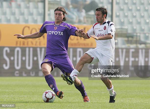 Riccardo Montolivo of Fiorentina in action against Mivhele Canini of Cagliari during the Serie A match between Fiorentina and Cagliari at Stadio...