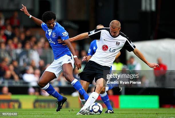 Joao Alves Jo of Everton and Brede Hangeland of Fulham compete for the ball during the Barclays Premier League match between Fulham and Everton at...