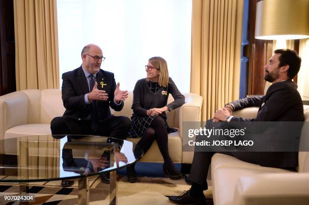 Newly elected Catalan parliament speaker Roger Torrent speaks with Junts per Catalunya's Elsa Artadi and Eduard Pujol during a meeting at the Catalan...