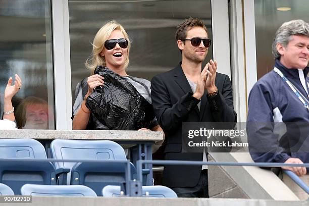 Actress Charlize Theron with actor Stuart Townsend watch the match between Rafael Nadal of Spain and Juan Martin Del Potro of Argentina during day...