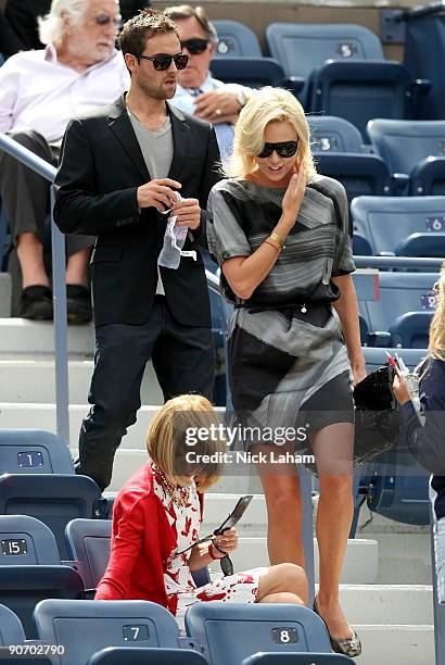 Actress Charlize Theron with actor Stuart Townsend walk to meet Editor-in-Chief of Vogue Anna Wintour to watch the match between Rafael Nadal of...