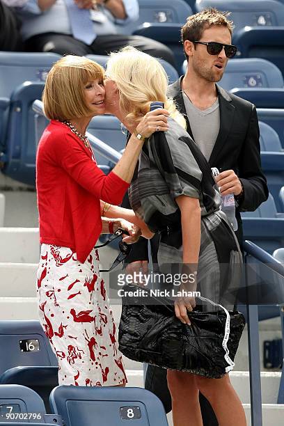 Editor-in-Chief of Vogue Anna Wintour greets actress Charlize Theron and actor Stuart Townsend at the match between Rafael Nadal of Spain and Juan...
