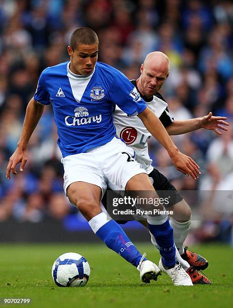 Jack Rodwell of Everton is challenged by Andrew Johnson of Fulham during the Barclays Premier League match between Fulham and Everton at Craven...