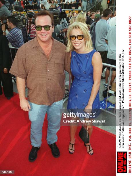 WestWood, Ca Tom Arnold and Wife Julie at the new movie premiere of the latest movie "Mission Impossible"