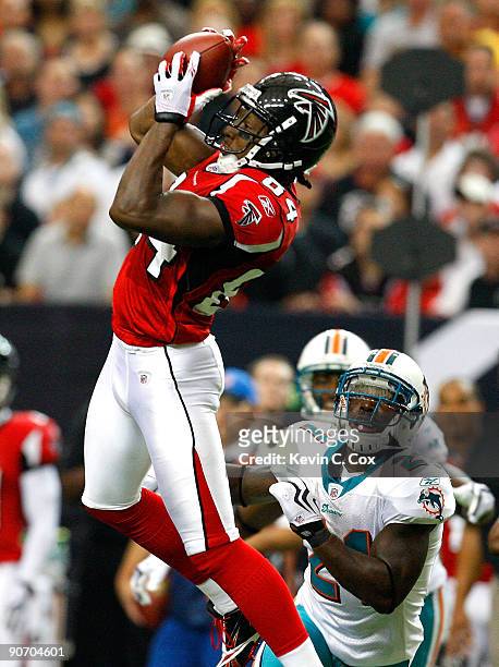 Roddy White of the Atlanta Falcons pulls in this reception against Christopher Owens of the Miami Dolphins at Georgia Dome on September 13, 2009 in...