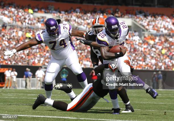 Adrian Peterson of the Minnesota Vikings is hit by D'Qwell Jackson of the Cleveland Brwons at Cleveland Browns Stadium on September 13, 2009 in...